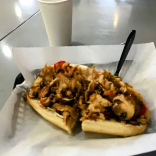 A fully loaded Philly chicken cheesesteak sandwich.