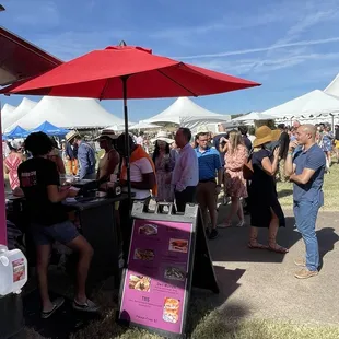 a large group of people standing under umbrellas