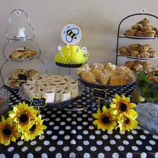Baby shower food table with pinwheel sandwiches, chicken salad croissants, MunchCake Spring salad, blueberry scones and banana nut muffins