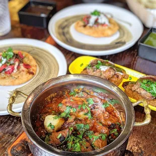 a variety of dishes on a wooden table