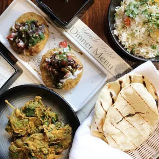 Tamarind chutney, kachori chaat, chickpeas with crispy spinach, flatbread, basmati rice