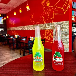 two bottles of soda on a table