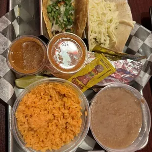 Taco Trio: traditional chicken taco, spicy supreme and tamale  come with beans and rice