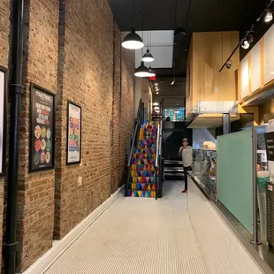 a woman walking down a long hallway