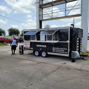 a man standing next to a food truck