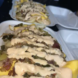 Loaded cheese fries included Bacon, onions, grilled jalapeños, bed of seasoned fries, cheese, and thousand island