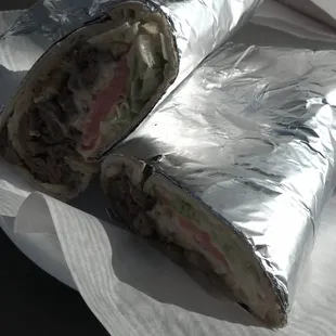 a sandwich wrapped in aluminum foil