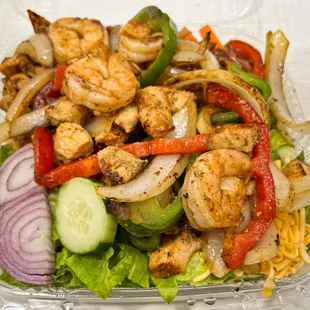 Shrimp and Chicken Fajita Salad, served with Homemade Green Sauce and choice of Dressing.