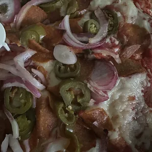 Vegan cheese pizza, with jalapeño, onion, and vegan pepperoni.