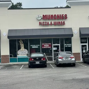 two cars parked in front of a restaurant