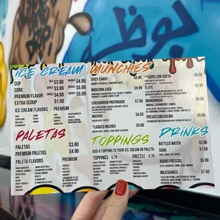 a person holding up a menu