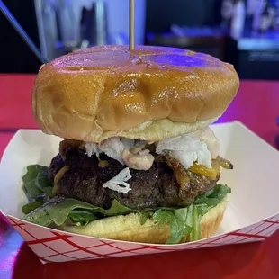 a hamburger with lettuce and onions