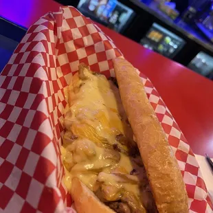 a hot dog with cheese and onions