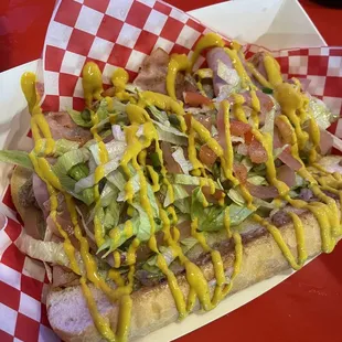 a hot dog with ketchup and lettuce