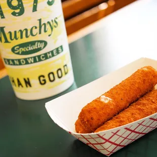 two fish sticks in a paper container