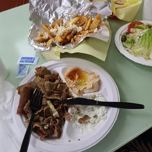 Gyros platter (half eaten) Greek fries, and side, salad! Yum!