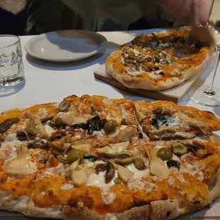 two pizzas on a table