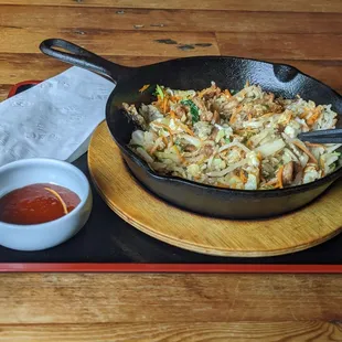 Bibimbap served in cast iron skillet.