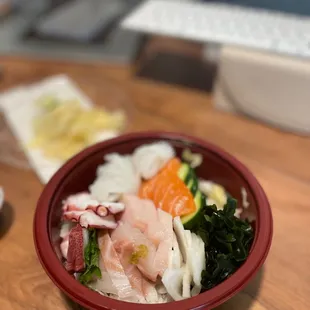 a bowl of food on a wooden table