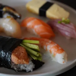 a plate of sushi on a black table