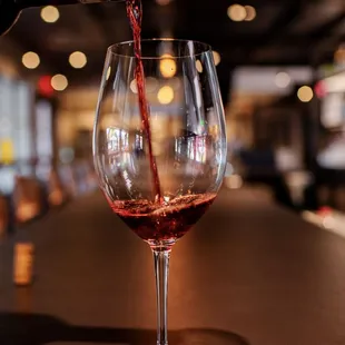a wine being poured into a wine glass