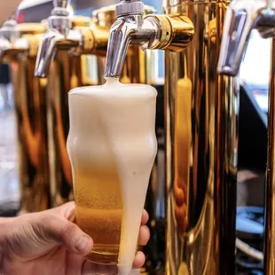 a person pouring a beer