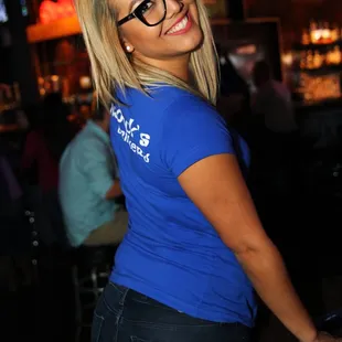 a woman in a blue shirt and glasses