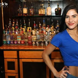 a woman standing in front of a bar