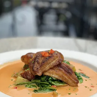 Blackened Mississippi Catfish: Creole seasoned filet, roasted red potatoes, spinach, Crystal Hot Sauce beurre (gf)