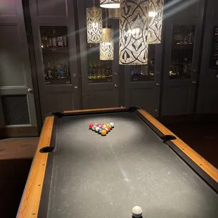 a pool table in the middle of the room
