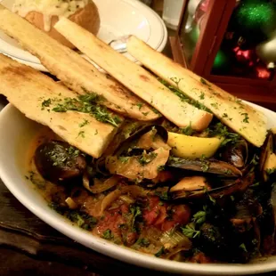 Steamed Chilean mussels in a spicy tomato broth with fennel, onions, garlic, huge stack of pasta &amp; French bread. Fantastic amazing!