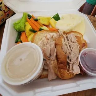 Open faced turkey sandwich takeout with gravy on the side
