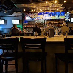 Nice bar area with seating around the bar and a community table just outside the bar area