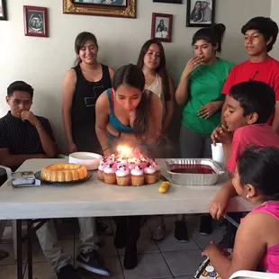 a woman blowing out candles on a cake