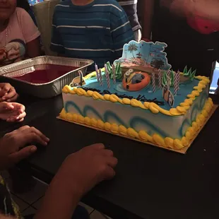 a birthday cake being cut