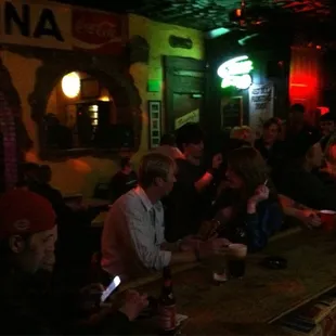 a group of people sitting at a bar
