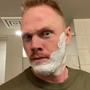 a man shaving his face