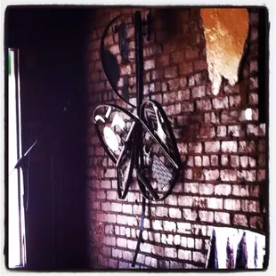 a bicycle leaning against a brick wall