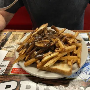 Hot Hamburger Poutine over hamburger patty with sweet onions on Texas Toast