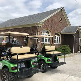 two golf carts parked outside