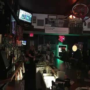 a bar with people sitting at the bar