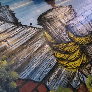 a mural of a man holding a bunch of bananas