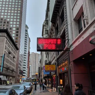 a neon sign on a city street