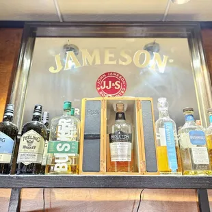 a shelf of liquor bottles