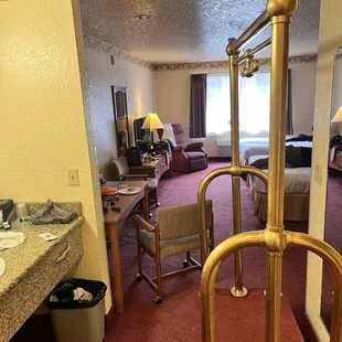 Spacious room with a kitchen area that has a wet bar sink, mini fridge and microwave... along with cabinets for storage