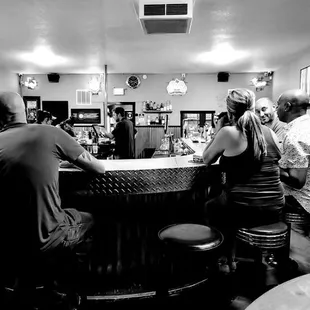 a group of people sitting at a bar