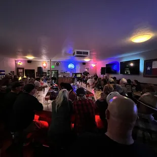 a crowd of people sitting at tables