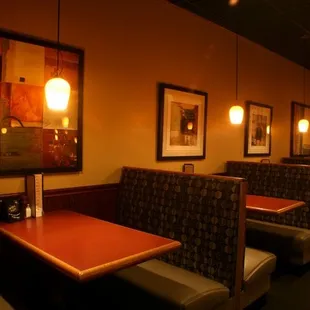 a row of booths with tables and chairs