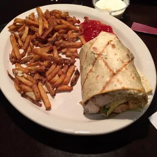 Spicy chicken wrap with fries