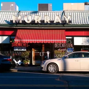 a white car parked in front of a restaurant